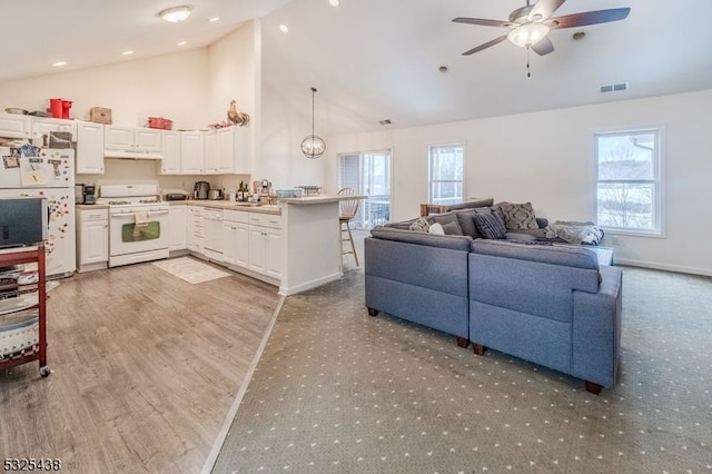 living room with ceiling fan, light hardwood / wood-style floors, sink, and high vaulted ceiling