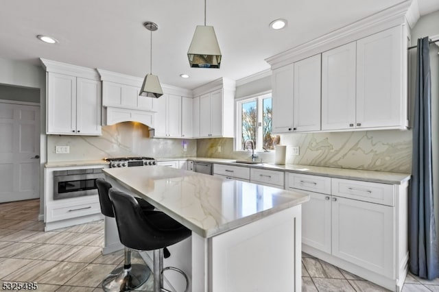 kitchen with backsplash, white cabinetry, a center island, and sink