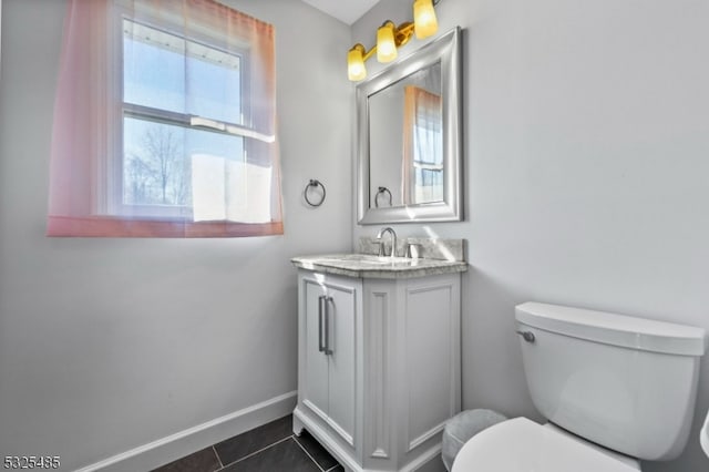 bathroom featuring tile patterned flooring, vanity, and toilet