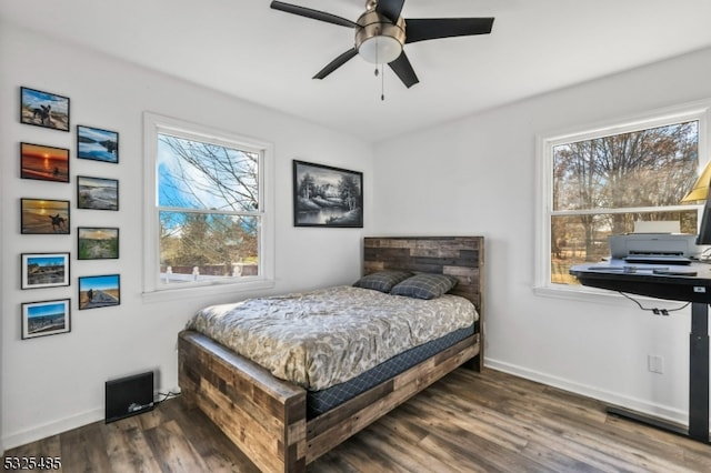 bedroom featuring dark hardwood / wood-style flooring and ceiling fan