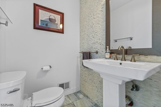 bathroom featuring tile patterned floors, toilet, and sink