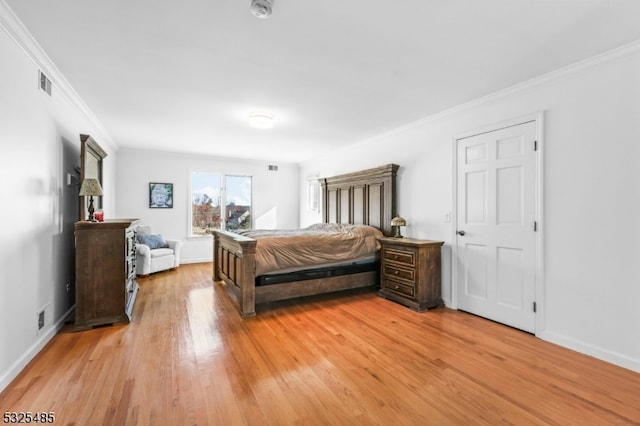 bedroom featuring light hardwood / wood-style floors and crown molding