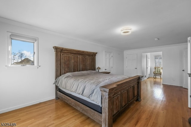 bedroom featuring ornamental molding and light hardwood / wood-style flooring