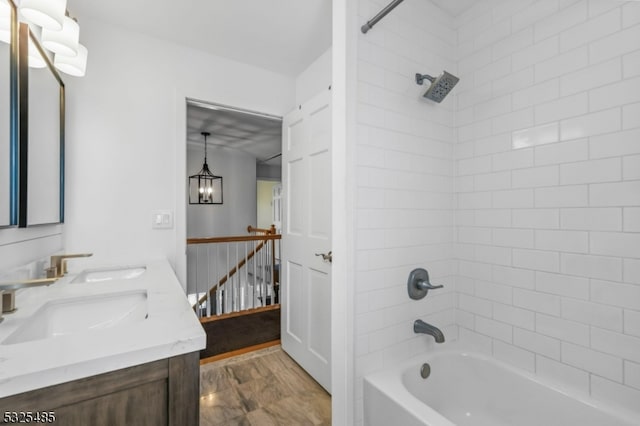 bathroom featuring vanity and tiled shower / bath