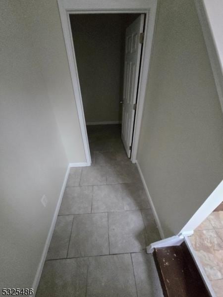 hall featuring light tile patterned floors