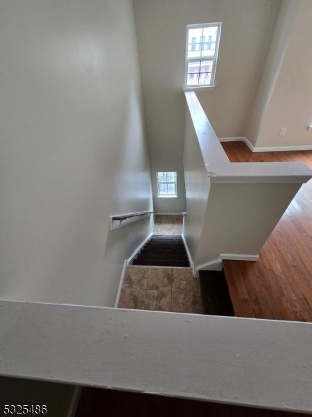 stairs featuring hardwood / wood-style floors