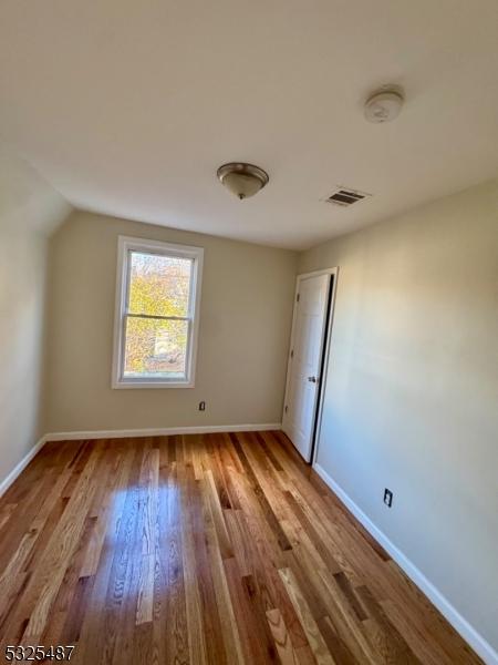 interior space with light wood-type flooring and vaulted ceiling