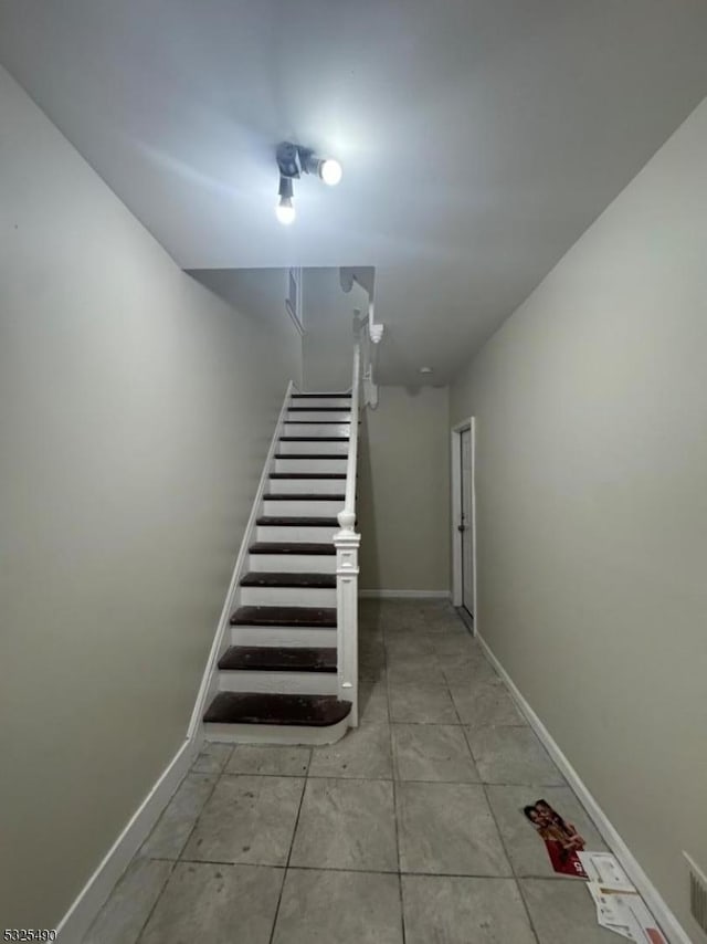 staircase featuring tile patterned floors