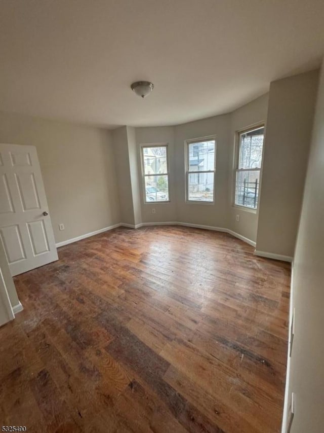 spare room featuring dark hardwood / wood-style flooring