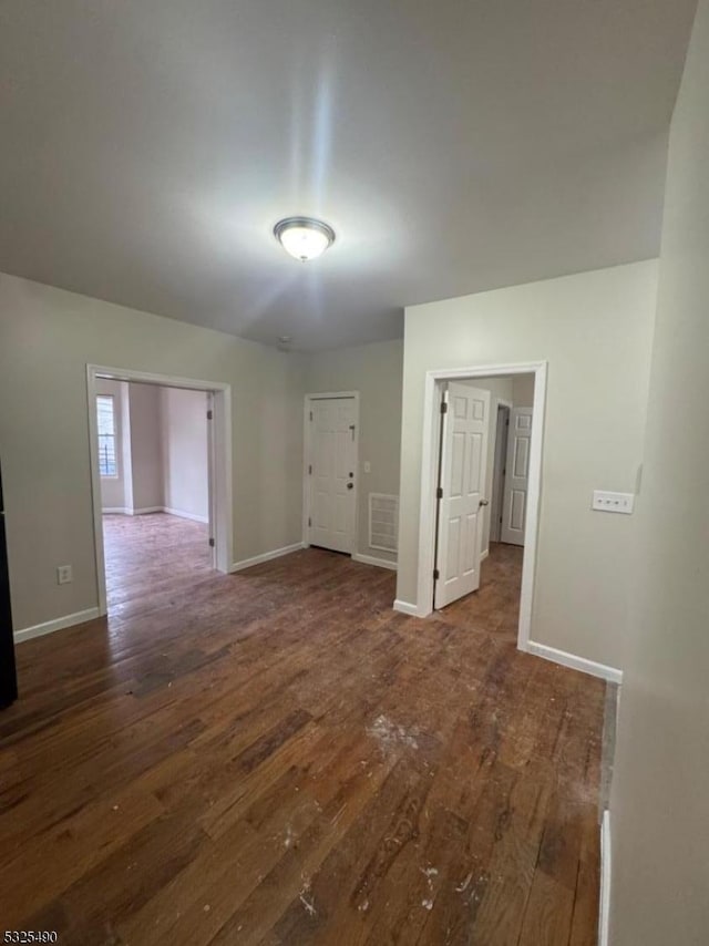 empty room featuring dark wood-type flooring