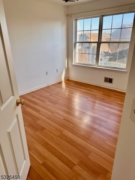 spare room with light wood-type flooring