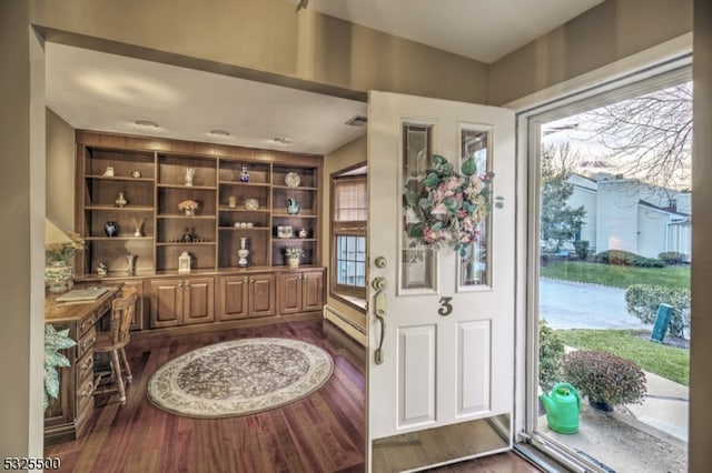 entrance foyer with dark hardwood / wood-style floors