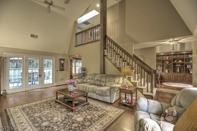 living room with ceiling fan, french doors, a baseboard radiator, high vaulted ceiling, and wood-type flooring