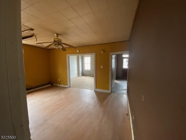 spare room featuring ceiling fan and light wood-type flooring