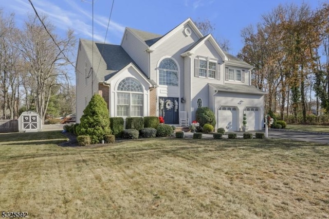 view of front of property featuring a storage unit, a garage, and a front yard