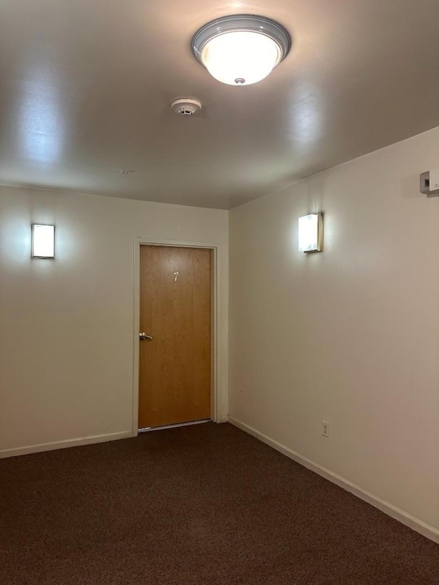 basement with dark colored carpet