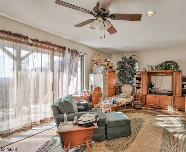 living room with ceiling fan and light hardwood / wood-style floors