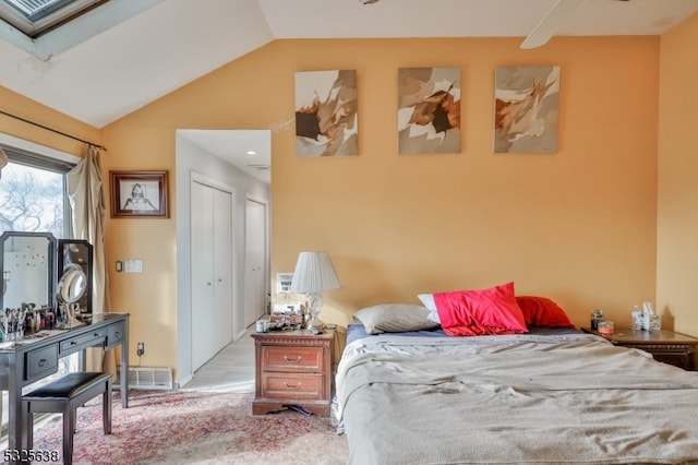 bedroom featuring a closet, light carpet, and vaulted ceiling