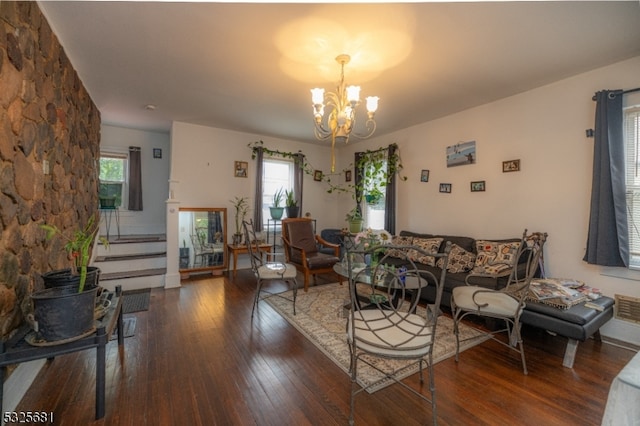 living room featuring a chandelier, dark hardwood / wood-style floors, and a wealth of natural light