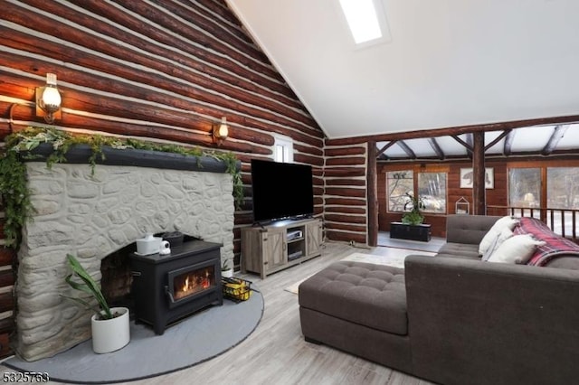 living area featuring high vaulted ceiling, plenty of natural light, log walls, and light wood finished floors