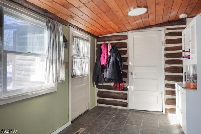 mudroom featuring dark tile patterned floors and wooden ceiling