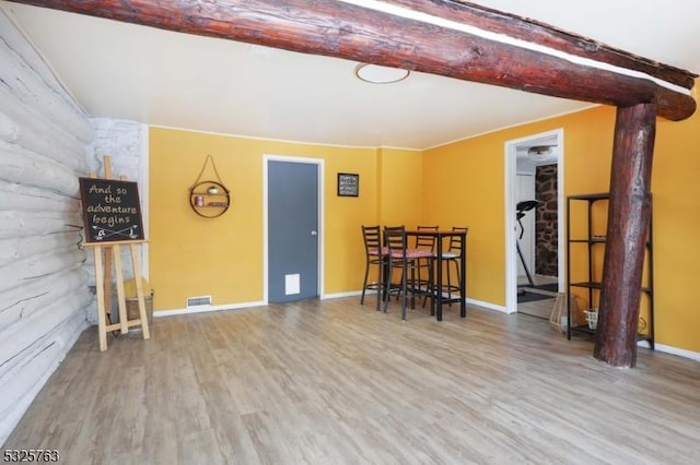 interior space with visible vents, baseboards, and wood finished floors