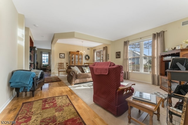 living room with a chandelier and light hardwood / wood-style flooring