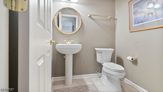 bathroom featuring tile patterned flooring and toilet