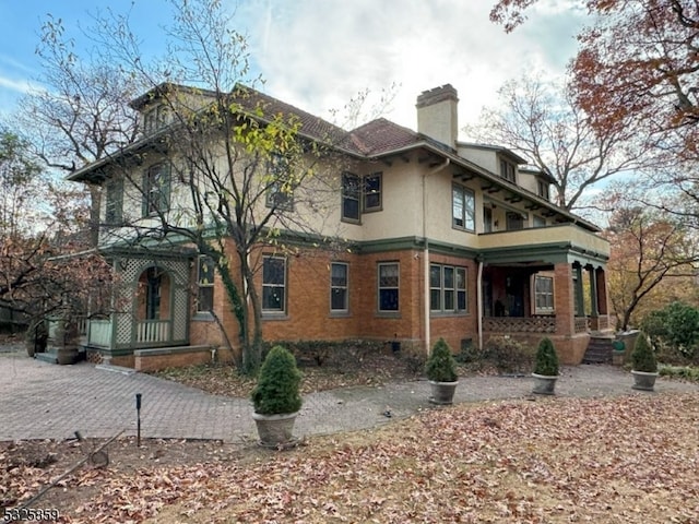 rear view of house with covered porch