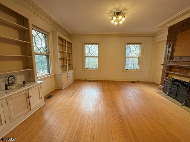 unfurnished living room with light hardwood / wood-style floors and a wealth of natural light