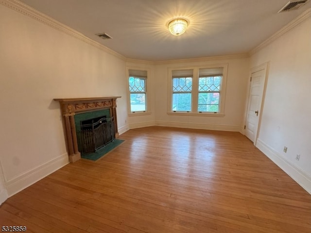 unfurnished living room featuring light hardwood / wood-style flooring and ornamental molding