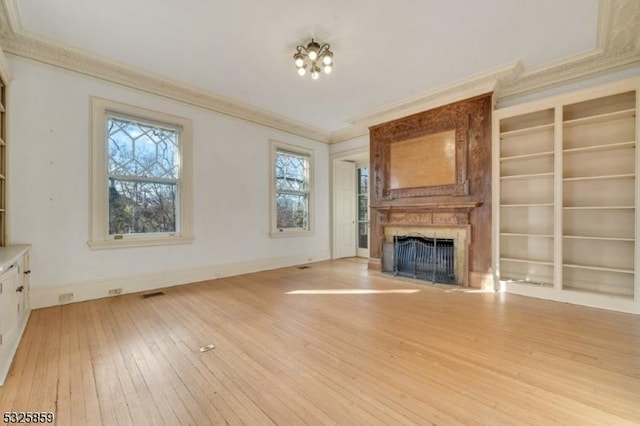 26 Ridge Rd, Summit City, NJ 07901 - unfurnished living room featuring light wood finished floors, ornamental molding, a fireplace, plenty of natural light, and built in shelves