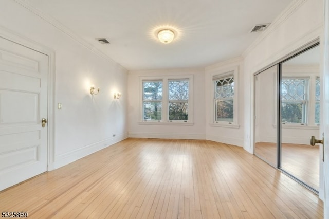 interior space with crown molding and light wood-type flooring