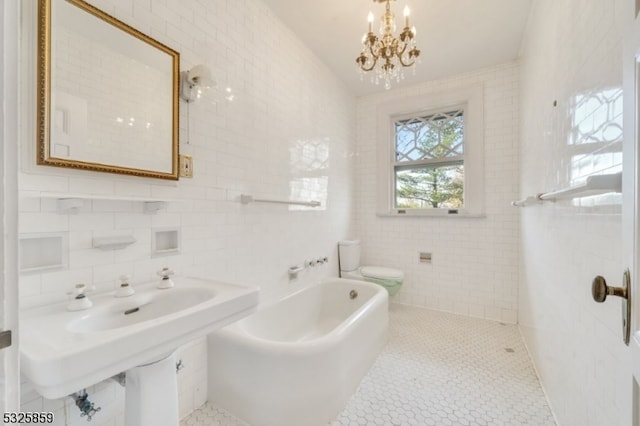 bathroom with toilet, a wealth of natural light, a bathing tub, and tile walls