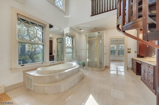 bathroom featuring plus walk in shower, vanity, and crown molding