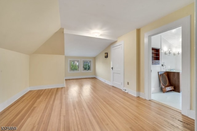 bonus room featuring hardwood / wood-style floors and vaulted ceiling