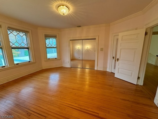 unfurnished bedroom featuring light hardwood / wood-style floors and ornamental molding