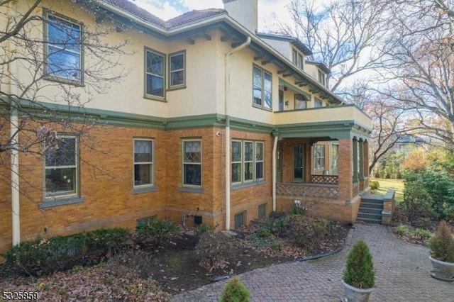 26 Ridge Rd, Summit City, NJ 07901 - view of side of home featuring a porch, stucco siding, and a chimney