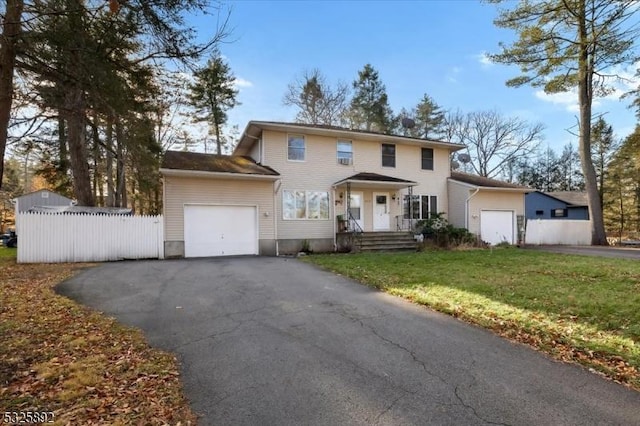 view of front of home with a garage and a front yard