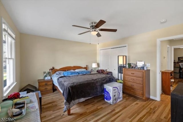 bedroom featuring ceiling fan, a closet, and light hardwood / wood-style flooring