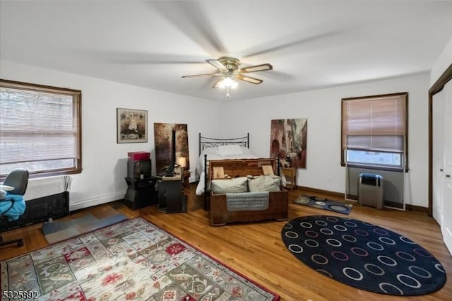 bedroom featuring wood-type flooring, a closet, and ceiling fan