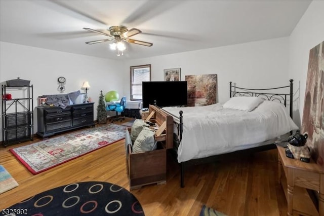 bedroom with wood-type flooring and ceiling fan