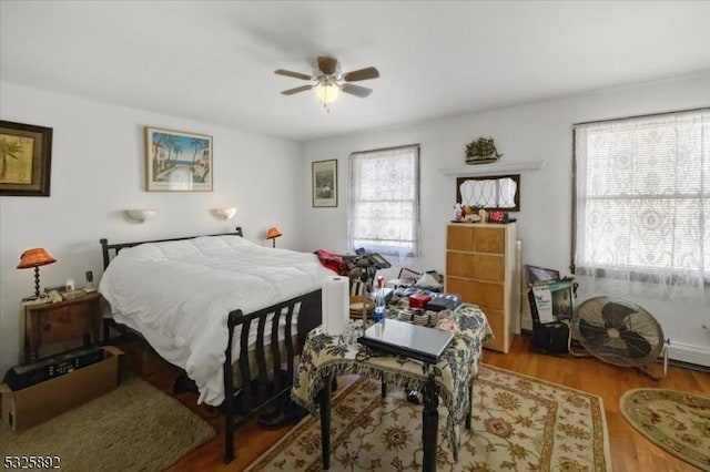 bedroom with light hardwood / wood-style flooring and ceiling fan