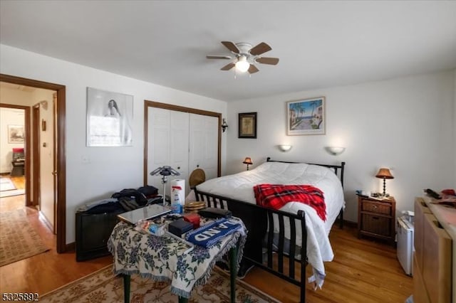 bedroom with ceiling fan, a closet, and light wood-type flooring