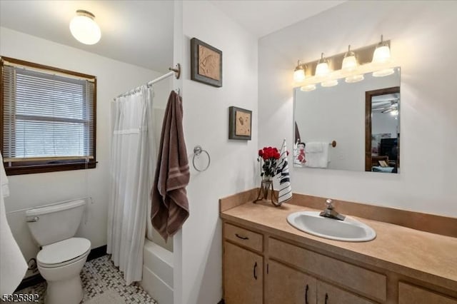 full bathroom with ceiling fan, tile patterned floors, shower / bath combination with curtain, toilet, and vanity