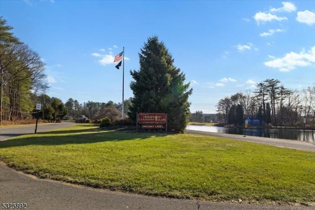 view of community featuring a yard and a water view