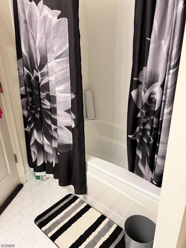 bathroom with tile patterned floors and shower / tub combo with curtain