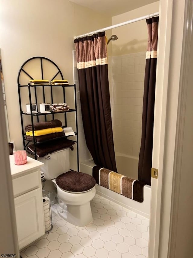 full bathroom with toilet, tile patterned floors, vanity, and shower / tub combo with curtain