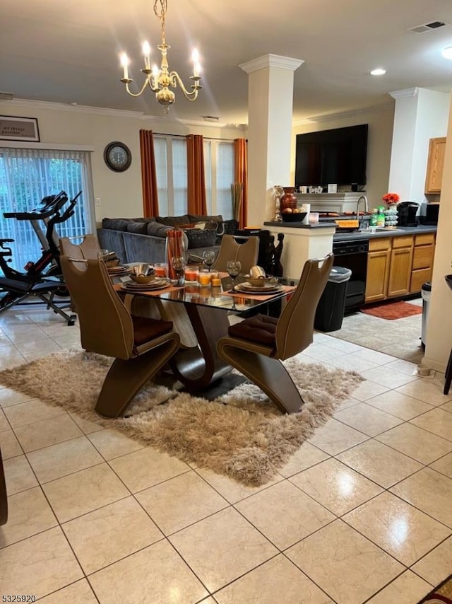 dining room with sink, light tile patterned floors, crown molding, and an inviting chandelier