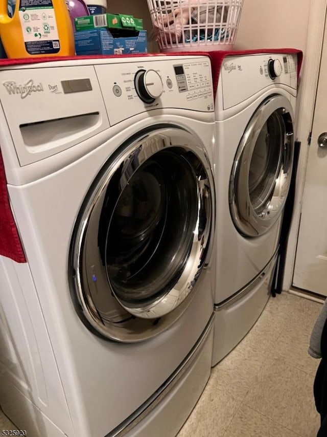 clothes washing area with washer and dryer